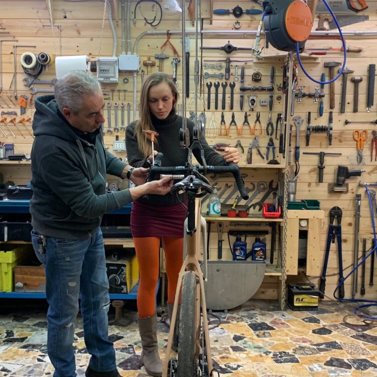 Mauro and Sophie are working on a bike in the workshop